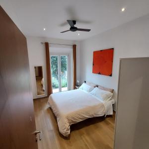 a bedroom with a bed and a ceiling fan at Amalia Suites - Via San Zanobi in Florence