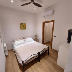 a bedroom with a bed with a ceiling fan at Amalia Suites - Via San Zanobi in Florence