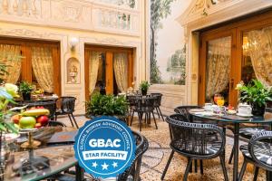 a restaurant with tables and chairs and a sign that says gbc steak return at Grand Hotel Majestic gia' Baglioni in Bologna