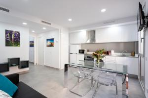 a kitchen with a glass table and some chairs at 8 lacus in Hospitalet de Llobregat