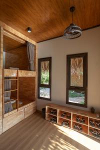 a room with a wine cellar with wooden cabinets and windows at Halise Sanctuary Ninh Binh in Ninh Binh +63 photos