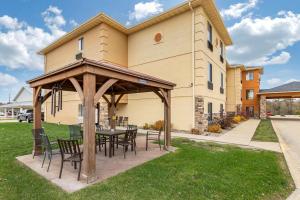 a patio with a table and chairs in front of a building at Comfort Inn & Suites Cedar Rapids North - Collins Road in Cedar Rapids