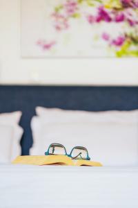 A bed or beds in a room at Aelia Apartments & Suites