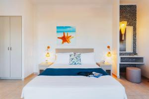 A bed or beds in a room at Aelia Apartments & Suites