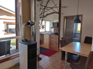 a room with a desk and a kitchen with a table at elephants Ferienhaus Haus Ost in Jahnsdorf