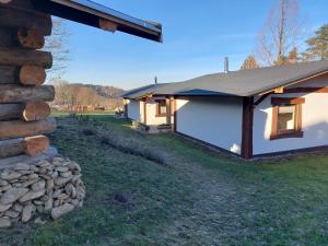 a house with a stone wall next to a building at elephants Ferienhaus Haus Ost in Jahnsdorf