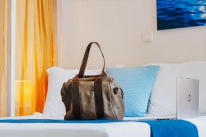 A bed or beds in a room at Aelia Apartments & Suites
