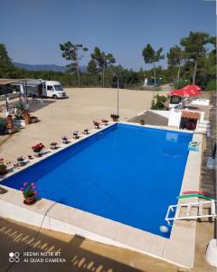 a large blue swimming pool in a parking lot at Habitaciones en casa rural particular La Casita in Ibi