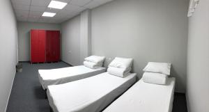 a hotel room with two beds and a desk at Hostel City Center in Chişinău