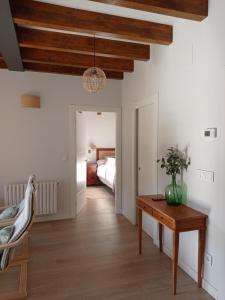 a bedroom with a bed and a table in a room at El Nogal de Hualle in Treceño