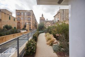 una pasarela en medio de una ciudad con edificios en Casa San Carlo, en La Valeta