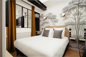 a bedroom with a white bed and a wall mural at My Maison In Paris Montmartre in Paris