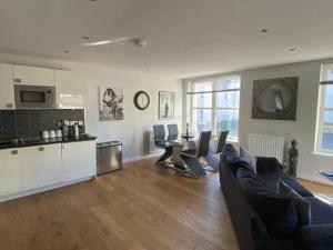 uma sala de estar com um sofá e uma mesa em Maltings Apartment - Spacious 2 Bed Ground Floor Apartment em Kirkcaldy