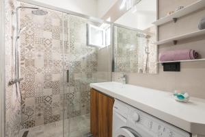 a bathroom with a shower and a washing machine at Apartments Marando in Dubrovnik +15 photos