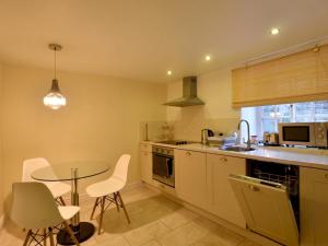 a kitchen with a table and a table and chairs at Pass the Keys Scampton Cottage in Lincoln