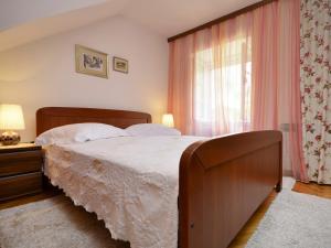 a bedroom with a large bed and a window at Holiday Home Stara Lipa in Baška Voda