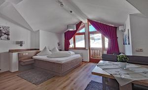 Sala de estar amplia con cama y mesa en Der Ottenhof en Walchsee