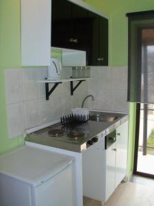 a kitchen with a sink and a counter top at Maria's Studios in Agios Georgios