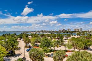 a view of a beach with palm trees and a city at SII Luxury 1 Bedroom close to the beach in West Palm Beach