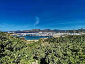 a marina with a bunch of boats in the water at Rokkaria Holidays Apartments in Villasimius