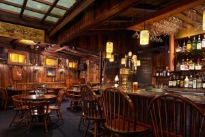a restaurant with tables and chairs and a bar at Concord's Colonial Inn in Concord