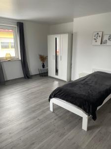 a bedroom with a bed with a black blanket at Diamant Apartment in Gattendorf