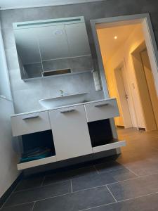 a bathroom with a sink and a mirror at Diamant Apartment in Gattendorf