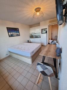 a bedroom with a bed and a table in it at Les Terrasses in Bormes-les-Mimosas