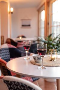 two glasses of red wine sitting on a table at Auberge & Campagne in Saint-Férréol-les-Neiges