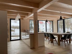 a kitchen and dining room with a table and chairs at Chalet Rokytnice in Rokytnice nad Jizerou