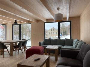 a living room with a couch and a table at Chalet Rokytnice in Rokytnice nad Jizerou