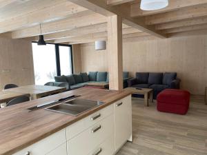 a kitchen and living room with a table and chairs at Chalet Rokytnice in Rokytnice nad Jizerou