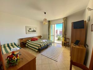 a living room with a bed and a table at Albergo Villa Ada in Borgio Verezzi