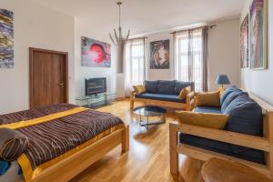 a living room with a bed and a couch at Apartment Sirius C in center of CB. in České Budějovice