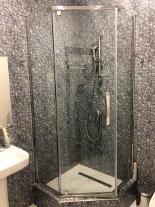 a shower with a glass enclosure in a bathroom at Korona Hotel in Kislovodsk