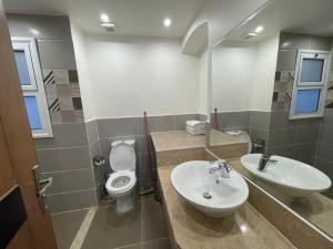 a bathroom with a toilet and a sink at Elgouna Downtown Property in Hurghada