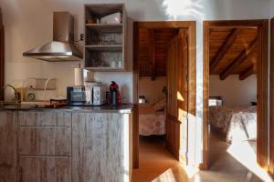 a kitchen with a counter top and a room with a bed at Apartamentos Top Medieval in Sigüenza