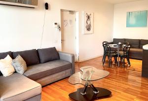 a living room with a couch and a table at Readyset Apartments at Verve in Melbourne