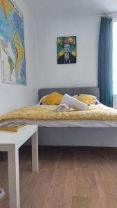 a large bed in a room with a table at Résidence Celestins - Appartements centre avec parking in Vichy