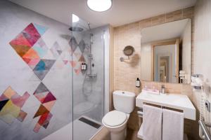 a bathroom with a shower and a toilet and a sink at Allegro Isora in Puerto de Santiago