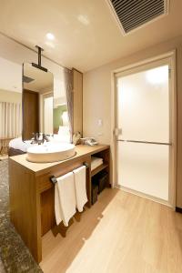 a bathroom with a sink and a mirror at Keisei Richmond Hotel Tokyo Kinshicho in Tokyo