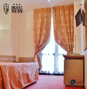 Postel nebo postele na pokoji v ubytování Hotel Nedy