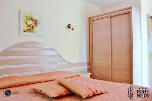 Postel nebo postele na pokoji v ubytování Hotel Nedy