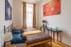 a bedroom with two beds and a desk at Apartment Sirius D in center of CB. in České Budějovice
