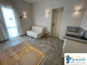 a kitchen with a sink and a couch in a room at SEASIDE Temporary House in Leporano Marina +64 photos