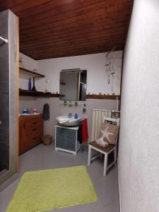 a small kitchen with a sink and a table at Au repos des remparts in Wissembourg