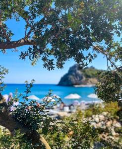 a view of a beach with umbrellas and the ocean at Datca Masal Gibi Plaj&Restaurant in Datca