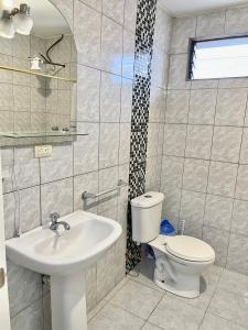 a bathroom with a toilet and a sink at VFC Suites Cuenca - Ecuador in Cuenca +26 photos
