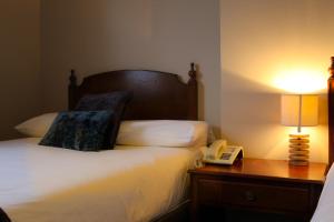 A bed or beds in a room at Bridge Hotel