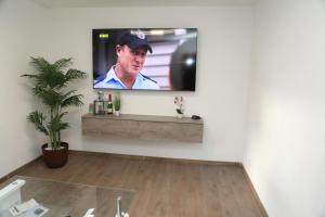 a living room with a flat screen tv on a wall at Ferienwohnung Kassel in Kassel